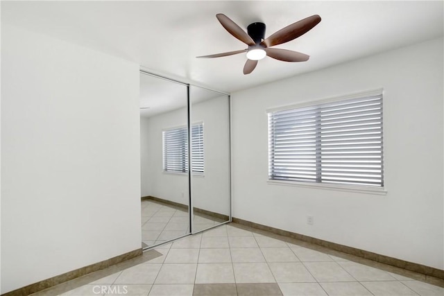 24409 Dunlavy Ct, Moreno Valley, CA 92557 - unfurnished bedroom featuring multiple windows, a closet, and a ceiling fan