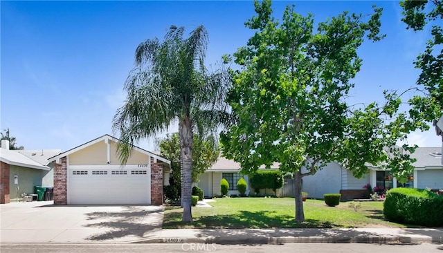 24409 Dunlavy Ct, Moreno Valley, CA 92557 - view of front of home featuring driveway, an attached garage, a front yard, and brick siding