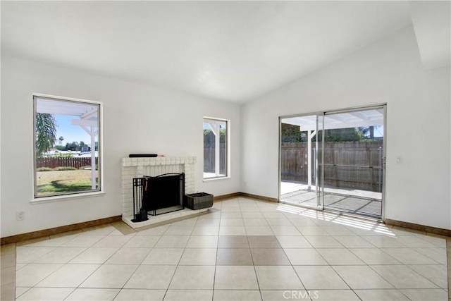24409 Dunlavy Ct, Moreno Valley, CA 92557 - unfurnished living room featuring vaulted ceiling, plenty of natural light, a fireplace, and light tile patterned flooring