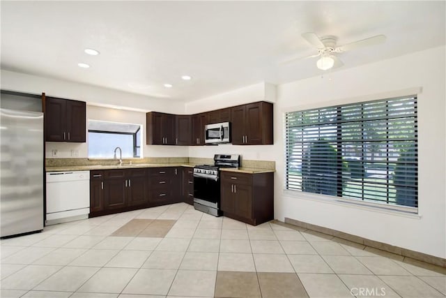24409 Dunlavy Ct, Moreno Valley, CA 92557 - kitchen featuring appliances with stainless steel finishes, dark brown cabinetry, ceiling fan, recessed lighting, and light tile patterned flooring