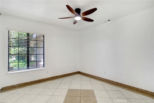 24409 Dunlavy Ct, Moreno Valley, CA 92557 - spare room featuring healthy amount of natural light, a ceiling fan, and light tile patterned floors