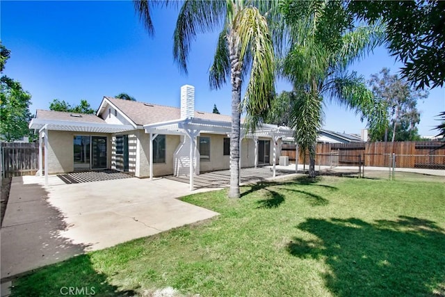 24409 Dunlavy Ct, Moreno Valley, CA 92557 - rear view of house with a pergola, stucco siding, a fenced backyard, and a patio