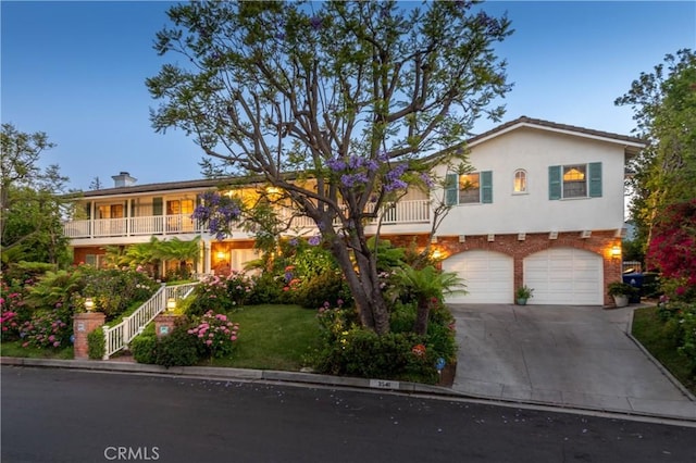3541 Westfall Dr, Encino, CA 91436 - front of property with concrete driveway, a garage, stairs, stucco siding, and a front lawn