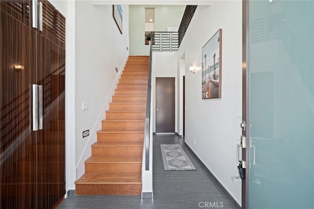 2623 Carnegie Ln, Redondo Beach, CA 90278 - stairway featuring baseboards and a towering ceiling