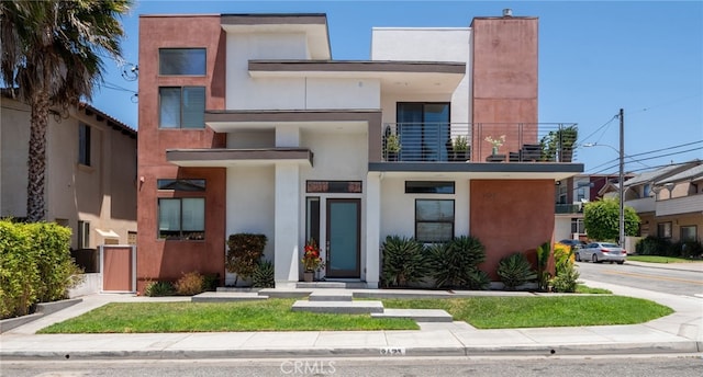 2623 Carnegie Ln, Redondo Beach, CA 90278 - view of front of property with a balcony and stucco siding