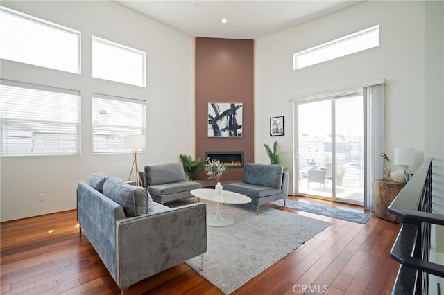 2623 Carnegie Ln, Redondo Beach, CA 90278 - living room featuring a high ceiling, a fireplace, dark wood-style floors, and recessed lighting