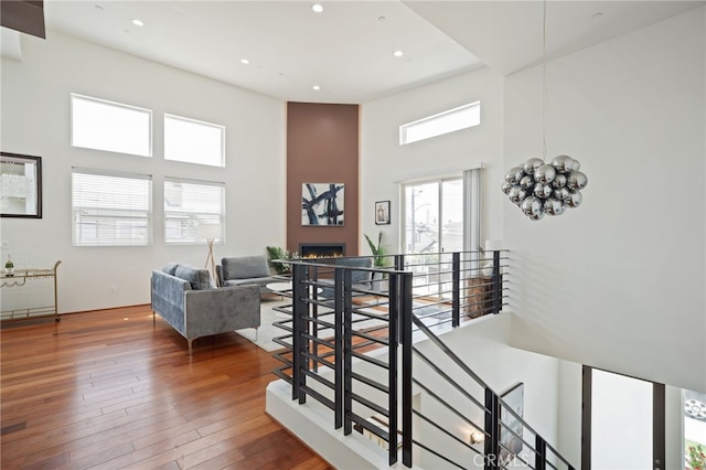 2623 Carnegie Ln, Redondo Beach, CA 90278 - stairs with a high ceiling, a large fireplace, hardwood / wood-style flooring, and recessed lighting