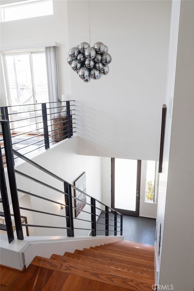 2623 Carnegie Ln, Redondo Beach, CA 90278 - staircase featuring healthy amount of natural light and a chandelier