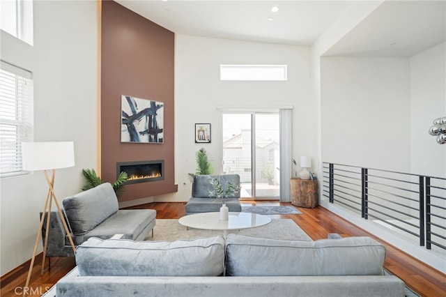 2623 Carnegie Ln, Redondo Beach, CA 90278 - living area featuring a high ceiling, a glass covered fireplace, and wood finished floors