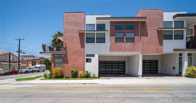 2623 Carnegie Ln, Redondo Beach, CA 90278 - view of front of home featuring a garage, stucco siding, concrete driveway, and a carport