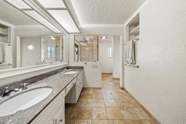 3204 Via Caliente Del Sol, Jamul, CA 91935 - full bathroom with a textured ceiling, double vanity, a textured wall, a shower, and stone finish flooring