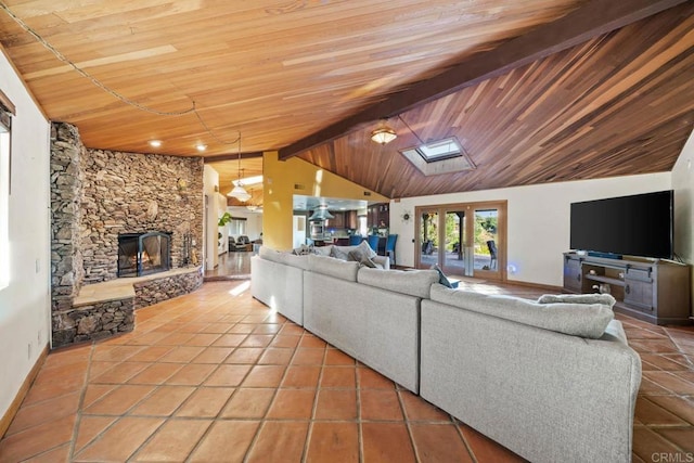 3204 Via Caliente Del Sol, Jamul, CA 91935 - tiled living room featuring wooden ceiling, a skylight, and a stone fireplace