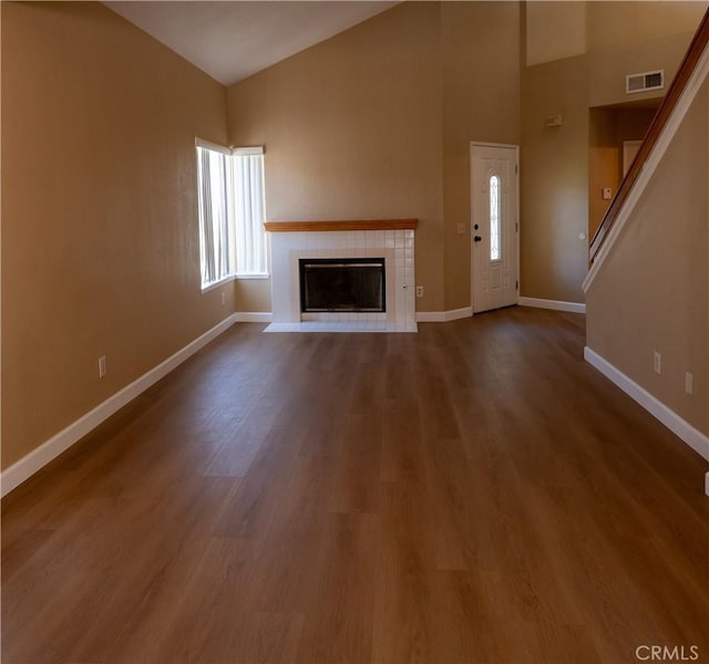 22760 Mountain View Rd, Moreno Valley, CA 92557 - unfurnished living room with a fireplace, high vaulted ceiling, dark wood-style floors, and stairway