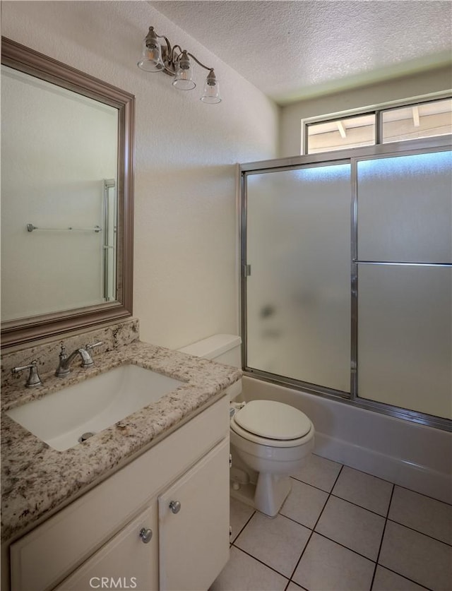 22760 Mountain View Rd, Moreno Valley, CA 92557 - full bath with vanity, enclosed tub / shower combo, tile patterned floors, and a textured ceiling