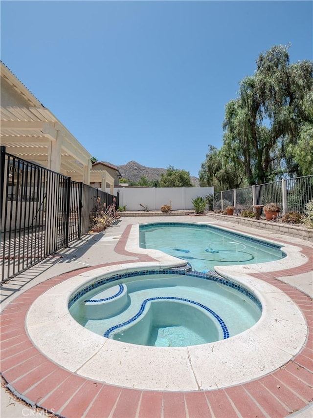 22760 Mountain View Rd, Moreno Valley, CA 92557 - view of swimming pool with a fenced backyard, a mountain view, and a pool with connected hot tub