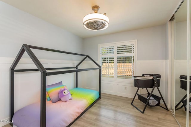 5684 Recodo Way, Camarillo, CA 93012 - bedroom featuring light wood finished floors, a decorative wall, and wainscoting
