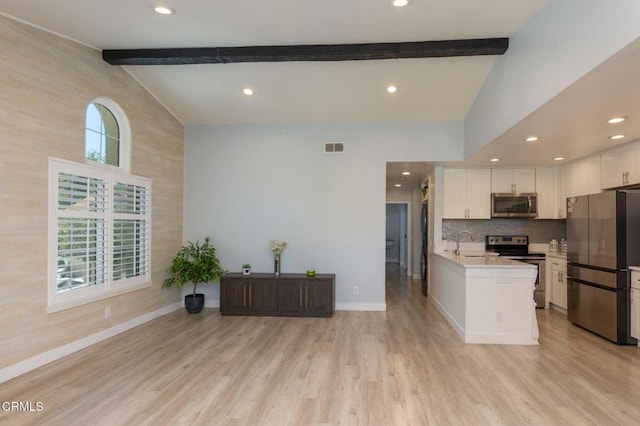 5684 Recodo Way, Camarillo, CA 93012 - kitchen featuring appliances with stainless steel finishes, beam ceiling, light countertops, white cabinets, and decorative backsplash