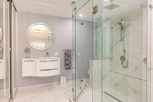 5684 Recodo Way, Camarillo, CA 93012 - bathroom featuring a marble finish shower, marble tiled floors, and vanity