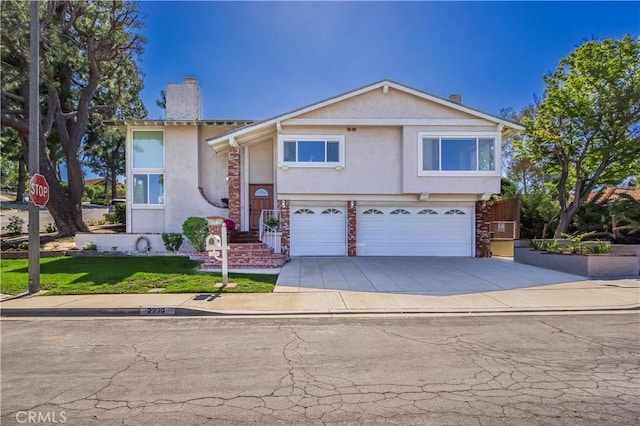 2239 Maystone Pl, Rowland Heights, CA 91748 - view of front of home featuring a garage, a chimney, stucco siding, and driveway