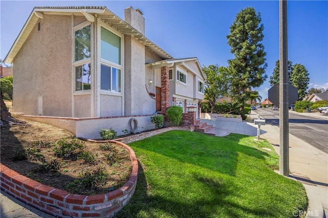 2239 Maystone Pl, Rowland Heights, CA 91748 - view of side of home with a chimney, stucco siding, and a lawn