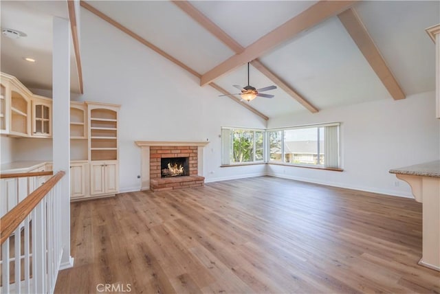 2239 Maystone Pl, Rowland Heights, CA 91748 - unfurnished living room with a ceiling fan, high vaulted ceiling, beamed ceiling, light wood-style flooring, and a brick fireplace
