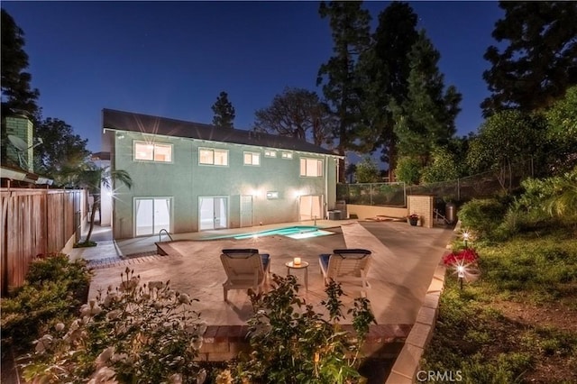 2239 Maystone Pl, Rowland Heights, CA 91748 - back of house at twilight featuring a patio and a fenced backyard