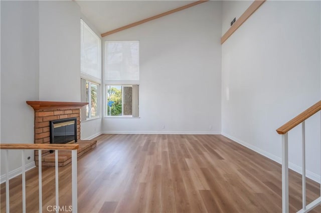2239 Maystone Pl, Rowland Heights, CA 91748 - unfurnished living room with high vaulted ceiling, a brick fireplace, and light wood-style floors