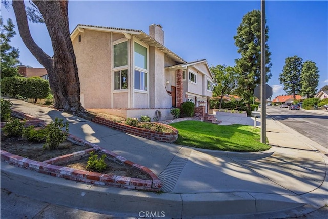2239 Maystone Pl, Rowland Heights, CA 91748 - view of front facade featuring a chimney, stucco siding, and a front lawn