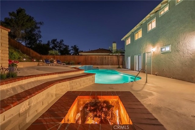 2239 Maystone Pl, Rowland Heights, CA 91748 - pool at night featuring a patio area, a fenced backyard, and a fire pit