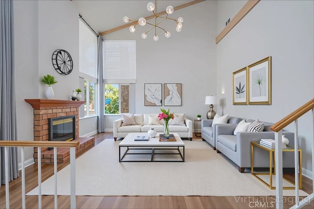 2239 Maystone Pl, Rowland Heights, CA 91748 - living area with high vaulted ceiling, wood finished floors, a chandelier, and a fireplace