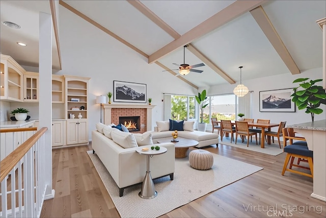 2239 Maystone Pl, Rowland Heights, CA 91748 - living room featuring high vaulted ceiling, beam ceiling, a brick fireplace, light wood finished floors, and ceiling fan