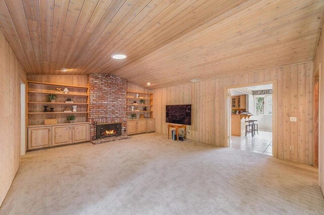 4678 Sun Vly, Del Mar, CA 92014 - unfurnished living room featuring a fireplace, wooden ceiling, built in features, wooden walls, and carpet