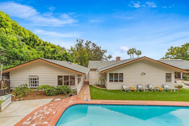 4678 Sun Vly, Del Mar, CA 92014 - rear view of house featuring a lawn, an outdoor pool, and a patio