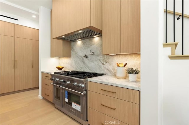 2206 Gates Ave Unit A, Redondo Beach, CA 90278 - kitchen with double oven range, custom range hood, light brown cabinetry, and light wood finished floors