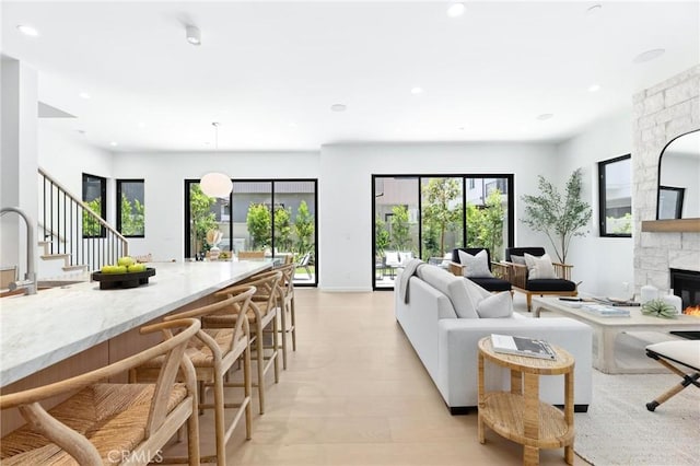 2206 Gates Ave Unit A, Redondo Beach, CA 90278 - living area with a stone fireplace, healthy amount of natural light, recessed lighting, and stairs