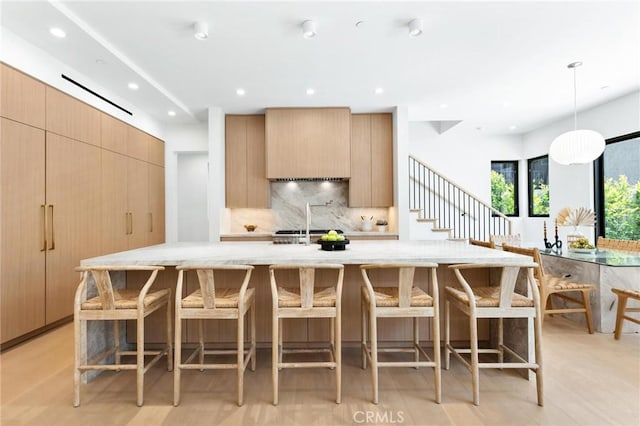 2206 Gates Ave Unit A, Redondo Beach, CA 90278 - kitchen featuring decorative backsplash, modern cabinets, light stone counters, recessed lighting, and a large island