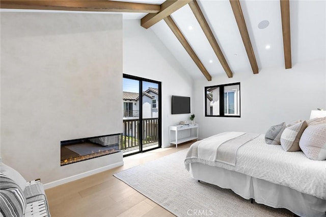 2206 Gates Ave Unit A, Redondo Beach, CA 90278 - bedroom with access to outside, wood finished floors, beam ceiling, a glass covered fireplace, and recessed lighting