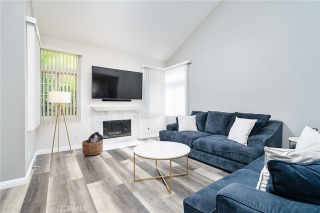 11718 Lucena Ave, Fontana, CA 92337 - living room with wood finished floors, a fireplace with flush hearth, and high vaulted ceiling