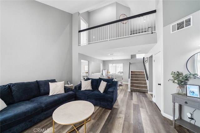 11718 Lucena Ave, Fontana, CA 92337 - living room with stairway, wood finished floors, a high ceiling, and a chandelier