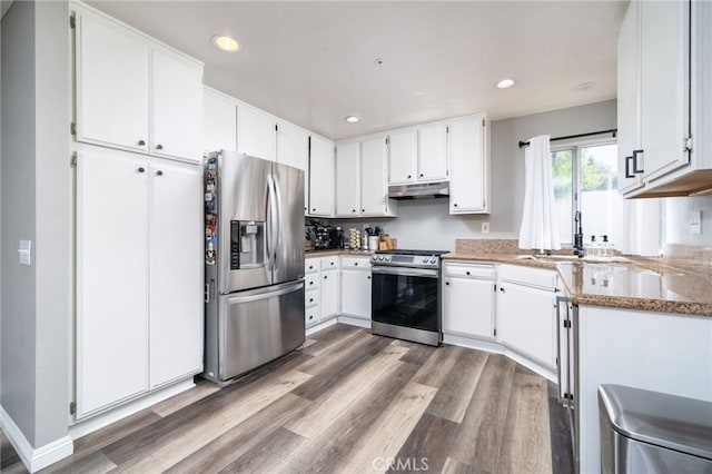 11718 Lucena Ave, Fontana, CA 92337 - kitchen featuring stainless steel appliances, under cabinet range hood, wood finished floors, white cabinets, and recessed lighting