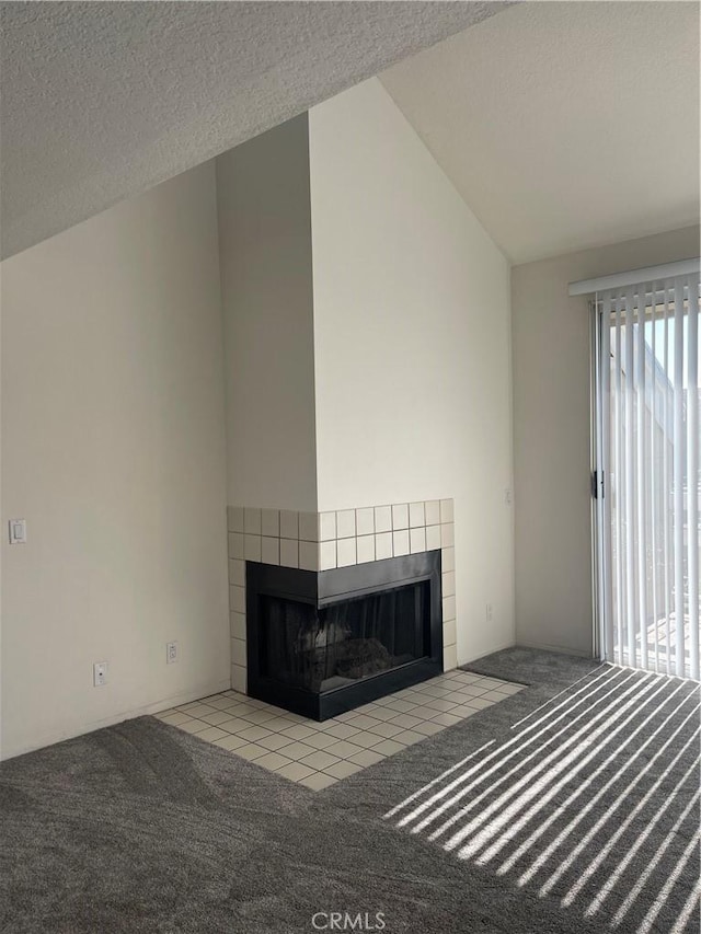 20301 Bluffside Cir Unit D406, Huntington Beach, CA 92646 - unfurnished living room featuring a tile fireplace, carpet flooring, lofted ceiling, and a textured ceiling