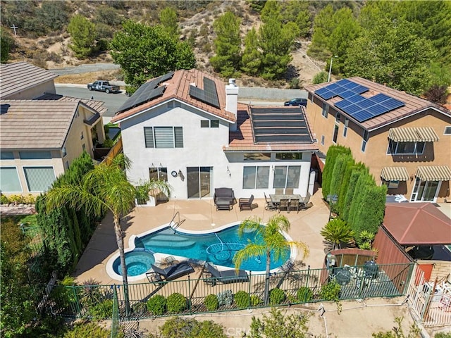 29508 Alyssum Ln, Canyon Country, CA 91387 - rear view of property featuring a fenced backyard, outdoor dining area, solar panels, and stucco siding