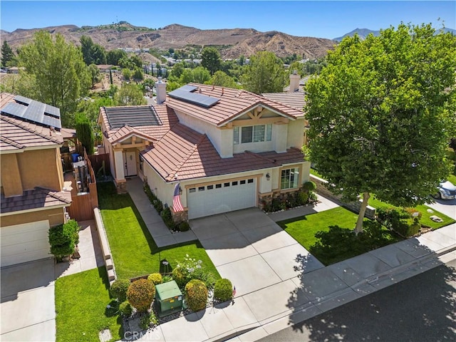 29508 Alyssum Ln, Canyon Country, CA 91387 - view of front of home featuring stucco siding, a tiled roof, driveway, roof mounted solar panels, and a mountain view