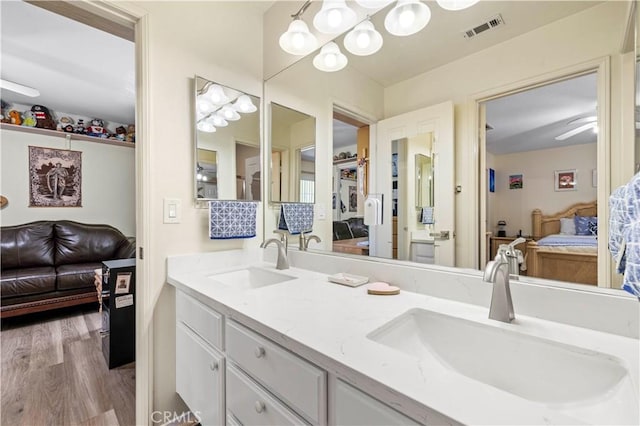 29508 Alyssum Ln, Canyon Country, CA 91387 - ensuite bathroom featuring double vanity, wood finished floors, and a chandelier