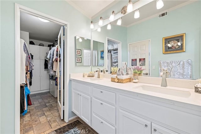 29508 Alyssum Ln, Canyon Country, CA 91387 - full bath featuring double vanity, crown molding, stone finish flooring, and a walk in closet