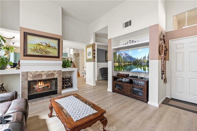 29508 Alyssum Ln, Canyon Country, CA 91387 - living area with a towering ceiling, light wood finished floors, and a tiled fireplace