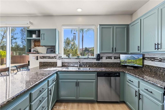 29508 Alyssum Ln, Canyon Country, CA 91387 - kitchen with dishwasher, dark stone countertops, and backsplash
