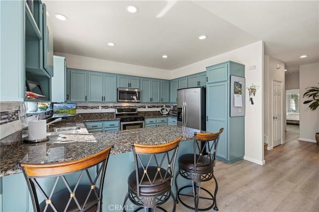 29508 Alyssum Ln, Canyon Country, CA 91387 - kitchen featuring stainless steel appliances, a peninsula, decorative backsplash, light wood-style floors, and recessed lighting