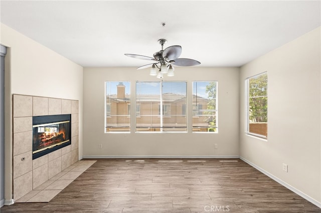 39719 Princeton Way Unit C, Murrieta, CA 92563 - unfurnished living room with ceiling fan, wood finished floors, and a tile fireplace
