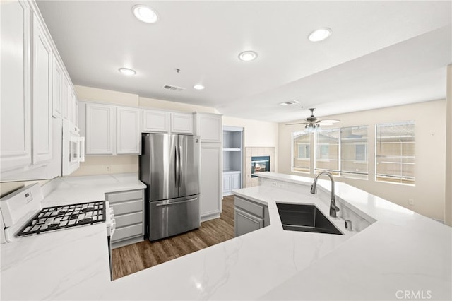 39719 Princeton Way Unit C, Murrieta, CA 92563 - kitchen featuring white appliances, ceiling fan, recessed lighting, white cabinetry, and dark wood-style floors